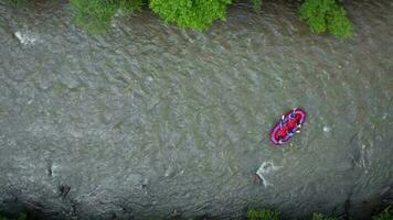 Aerial view of group of people on a rafting trip in an rubber dinghy video