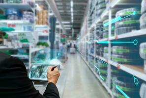 Innovative, inspecting the inventory of goods in the warehouse business with technology photo