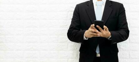 Business men hold smartphones to check information at the office photo