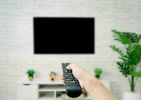Hand hold living room tv remote control photo