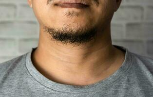 man asia with a long beard on the chin close up photo