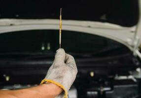 Auto mechanic Repair maintenance Check engine oil level and car inspection photo