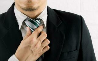 Business people hold a tie on a suit photo