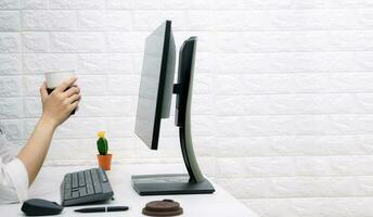 Relax working online business holding coffee cup on the desk to work photo