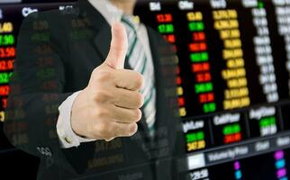 Business finance and the stock market get thumbs up from a businessman. photo