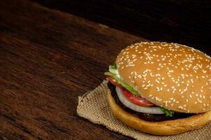 hamburguesa carne y vegetales en de madera antecedentes foto