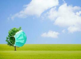 Concept tree wearing a mask to protect environment photo