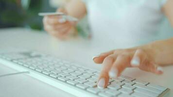 Woman typing credit card number on computer keyboard. She making online purchase. Online payment service video