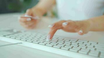 Woman typing credit card number on computer keyboard. She making online purchase. Online payment service video