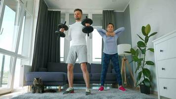 Caucasian couple doing strength training at home in cozy bright room video