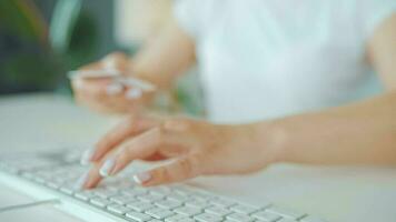 Woman typing credit card number on computer keyboard. She making online purchase. Online payment service video