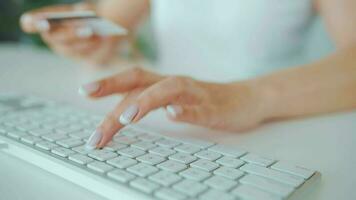 Woman typing credit card number on computer keyboard. She making online purchase. Online payment service video