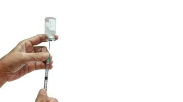 holds a syringe with a liquid vaccine on a white background photo