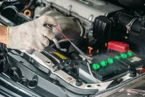 Auto mechanic Repair maintenance and car inspection cleaning battery photo