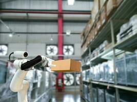 Industrial technology using robots mechanical arm the box in the factory photo