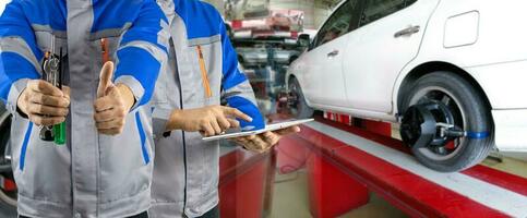 Auto mechanic analyzes and aligns automobile wheels. The car checks the wheel sensors on for wheels alignment photo
