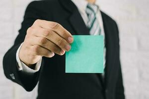 Business man holding card paper post-it notes photo