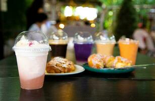 Glass of juice and sweets on the table photo