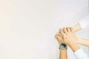 hands showing unity and teamwork clasped cooperation top view of people putting their hands photo