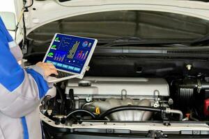 Auto mechanic use computer technology auto repair in auto service centers photo