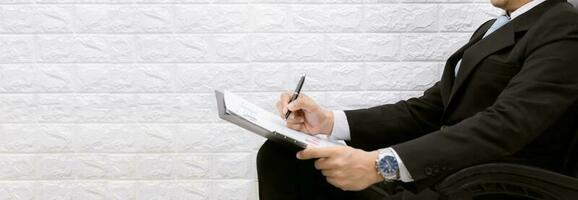 business man working on documents looking on a chair photo