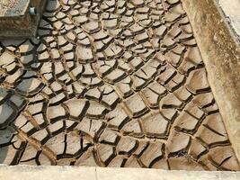 Dry and cracked soil or sediment of the treatment pond photo