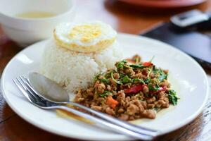 close up thai food, minced pork stir-fry with fried egg photo