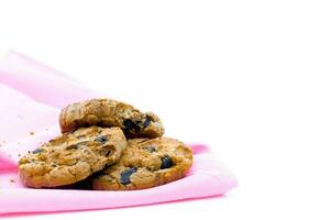 Chocolate cookies on a pink fabric white background photo