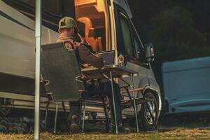 Men Making Business Phone Call While Camper Camping photo