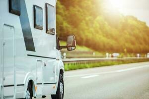 Short Mobile Camper Riding On The Road During Vacation. photo