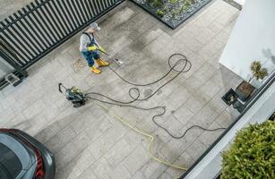 Home Owner Pressure Washing His Dirty Driveway photo