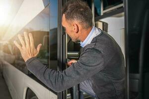 Men Waving to Someone Leaving in a Bus Goodbye Gesture photo