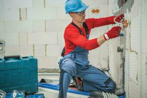 Professional Electrician Installing Power Plugs photo