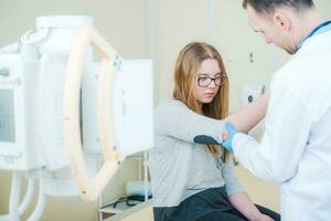 Doctor Examining Broken Arm photo