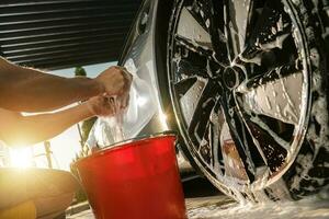 Cleaning Modern Car Alloy Wheels Using Special Detergent photo
