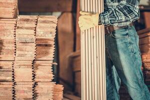 Contractor Worker with Wood Planks in Hand For Construction Project photo