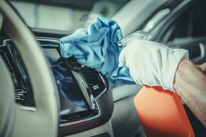 Men Cleaning Modern Car Dashboard photo