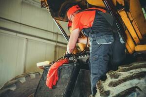 Heavy Machinery Mechanic Performing Tractor Maintenance photo