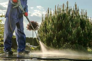 Gardener Washing Garden Paths photo