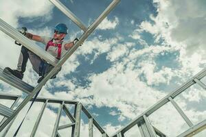 Construction Worker Attaches Pieces In Aluminum Structure. photo