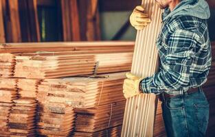 Stack Of Wooden Planks At Lumber Store. photo