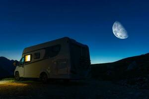 Camper Van and Clear Night Sky Over Camping Pitch photo