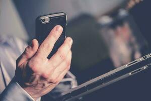 Businessman On Call Holding Cell Phone In Hand. photo