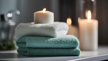 Soft blue towels folded on wooden table, candle illuminates foreground generated by AI photo