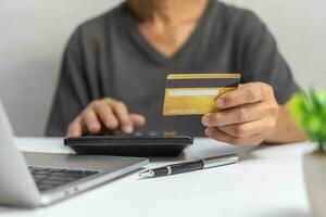 man using credit card for Online shopping, internet banking, store online, payment, spending money, e-commerce payment concept. photo