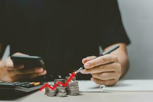 Business finance investments economy stack coin inflation and arrow red showing percentage on desk.increase and economic profit growth concept. photo