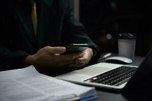 Businessman Checking Business Documents on Phone and Computer. Business concept report marketing and strategy working finance, accounting and tax, job application history. photo