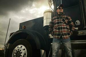 Commercial Semi Truck Driver in Front of His Vehicle photo