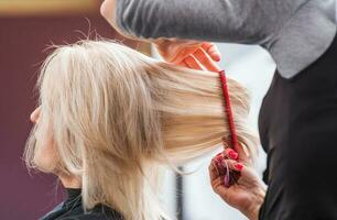 Blond Woman Hair Styling photo