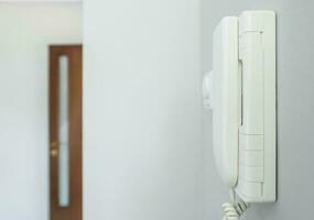 Home Intercom System Wired Talking Device on a Wall photo